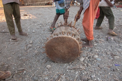 As the sun begins to set, the kids play around a drum that will later be used in a ceremony to honor their ancestors. (Photo by Maria Bakkalapulo)